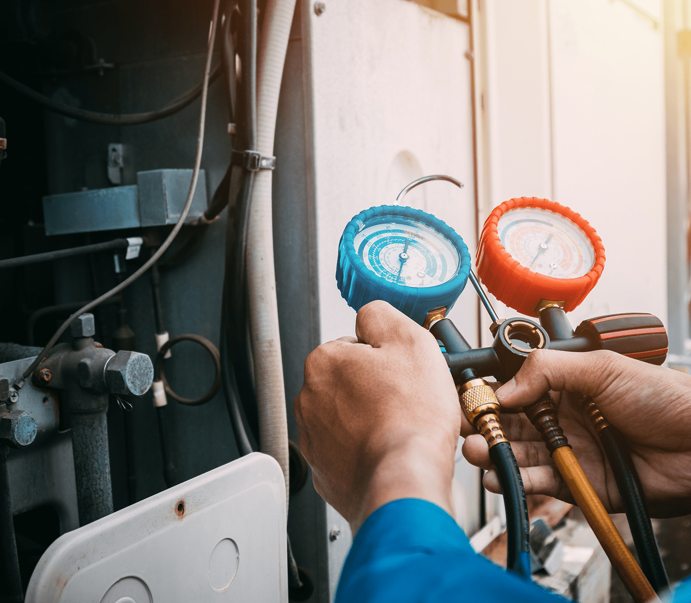 HVAC technician checking pressure gauges.